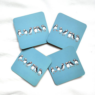 Four blue coasters with puffin illustrations on a white background by Shoeless Joe