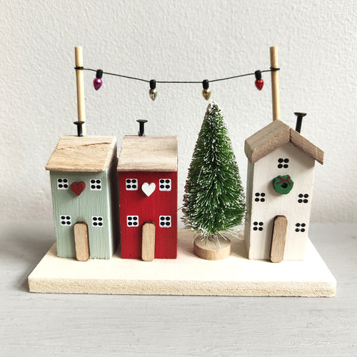 Row of colourful wooden houses dressed for Christmas