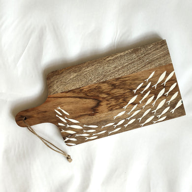 Wooden cutting board with fish cutout design on a white background by Shoeless Joe