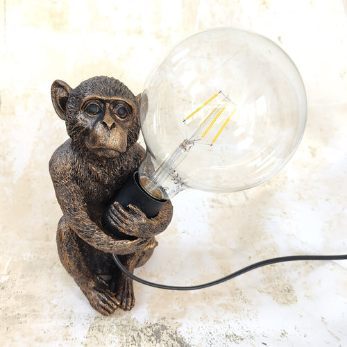 Monkey holding bulb lamp by Originals