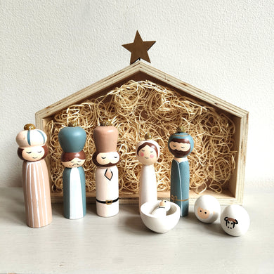 Wooden nativity set with stable and star on a white background by Shoeless Joe