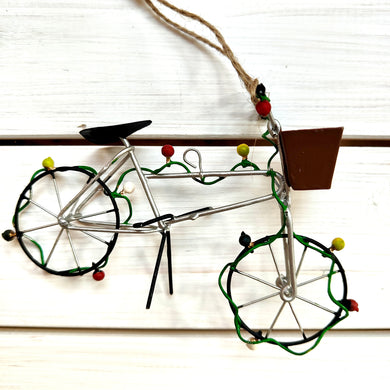 Decorative wire bicycle ornament on a white background featuring Christmas fairy lights.  By Shoeless Joe